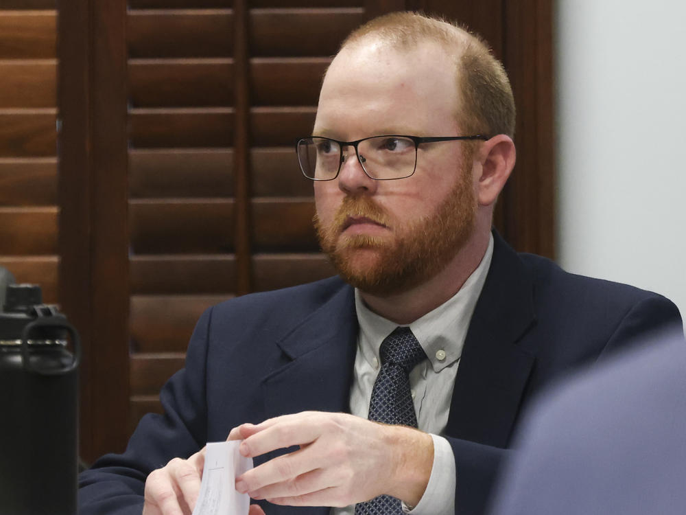 Travis McMichael, his father and a family friend are facing murder charges over the killing of Ahmaud Arbery in February of 2020. He's seen here in a courthouse in Brunswick, Ga.