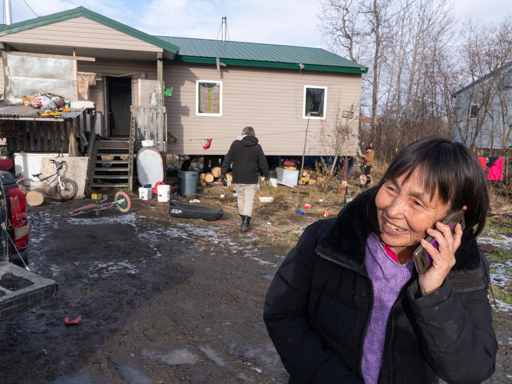 Technicians and engineers install antennae receivers on Lena Foss' home in Akiak, Alaska. Internet speeds will double in the town later this month, when it gains access to broadband internet.