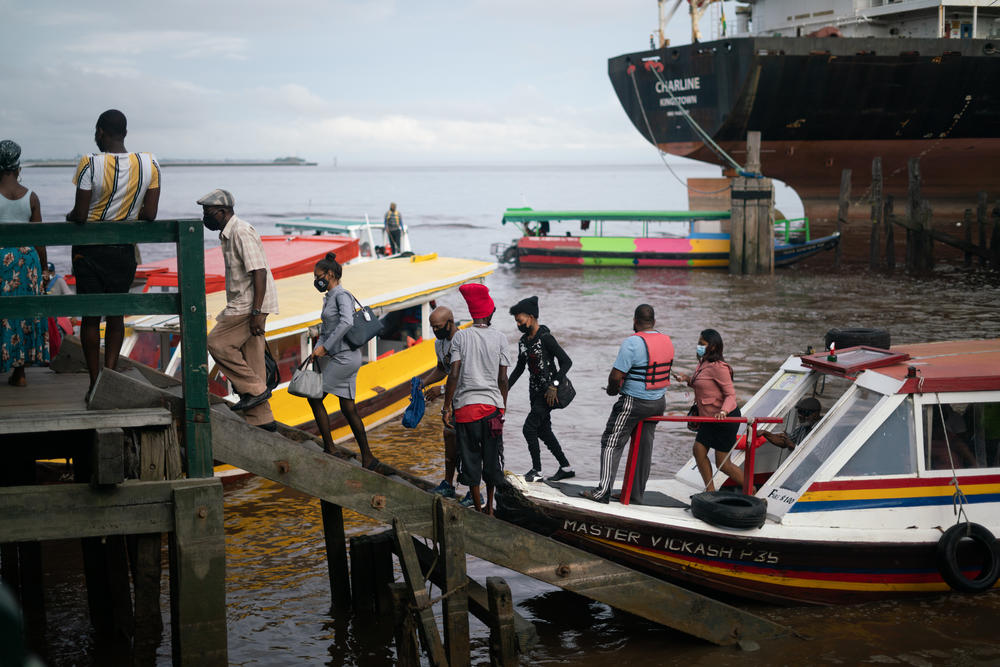 Commuters land at a port near Stabroek Market in Georgetown. The seawall that stretches along Guyana's coast can be traced back to Dutch colonizers, who reclaimed the low-lying, marshy plains to expand their land.