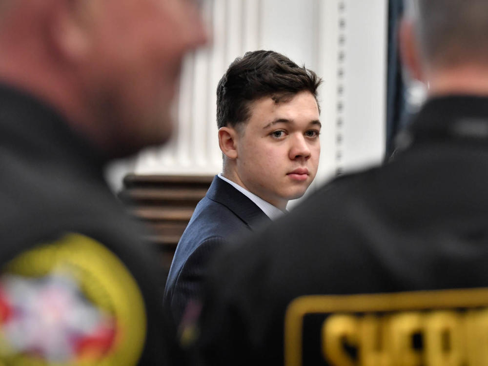 Kyle Rittenhouse, center, looks back as Kenosha County Sheriff's deputies enter the courtroom to escort him out of the room during a break in the trial at the Kenosha County Courthouse in Kenosha, Wis., on Friday, Nov. 5.