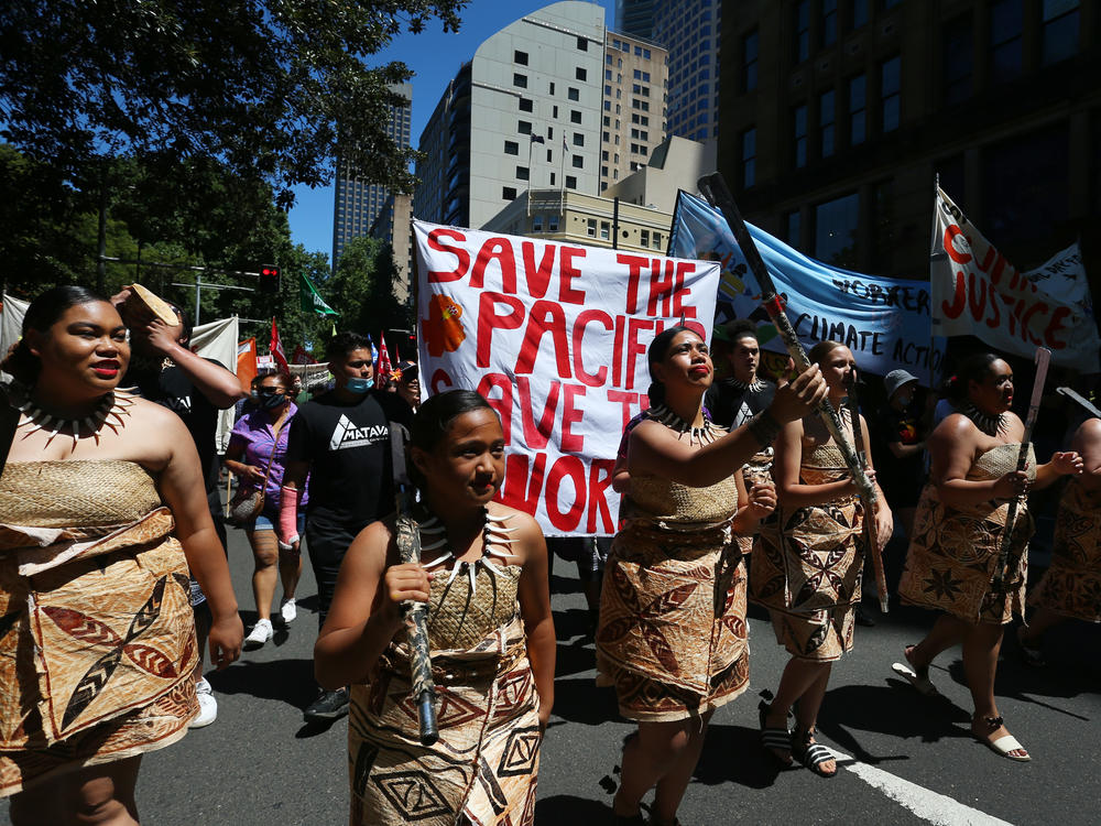 Climate activists march in Sydney during a COP26 protest on Saturday that was one of several demonstrations held around the world.