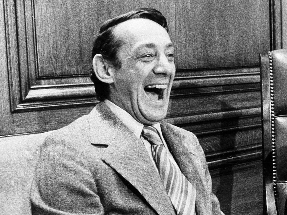 In this April 1977 file photo, San Francisco supervisor Harvey Milk sits in the mayor's office during the signing of the city's gay rights bill in San Francisco. The Navy is naming a ship in honor of the late gay rights leader, who served in the Navy for four years before he began a career in San Francisco city government.