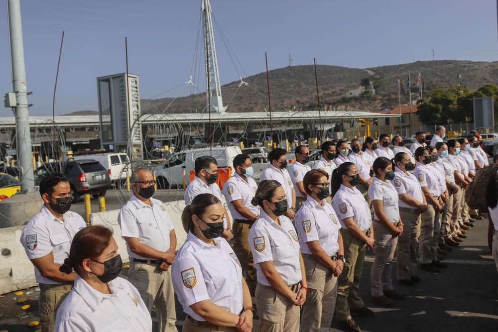Mexican immigration officials greet motorists at the Mexico-U.S.border at the San Ysidro Port of Entry in Tijuana, Mexico.