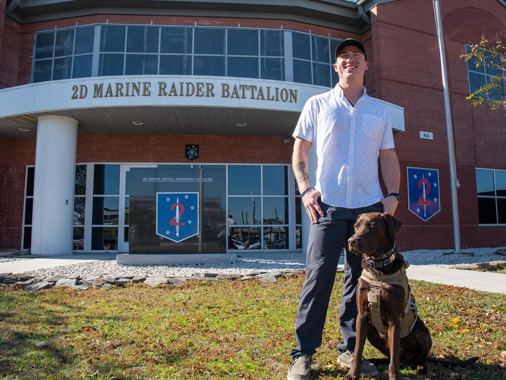 Nick Jones at Marine Corps Base Camp Lejeune in Jacksonville, N.C., on Nov. 8 with his dog Fletcher. This Veterans Day will be Nick's first day as a civilian upon leaving the Marine Corps.