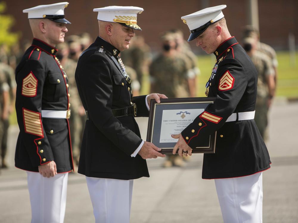 Staff Sgt. Nick Jones (right) is awarded the Navy Cross by the commandant of the Marine Corps, Gen. David Berger, on Aug. 26.