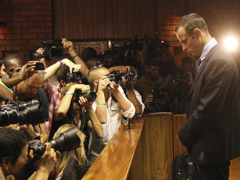 Photographers take photos of Olympic athlete Oscar Pistorius as he appears at a bail hearing for the shooting death of his girlfriend Reeva Steenkamp, in Pretoria, South Africa, Feb 20, 2013. Eight years after he shot dead his girlfriend, Pistorius is up for parole, but first he must meet with her parents as part of the parole procedure.