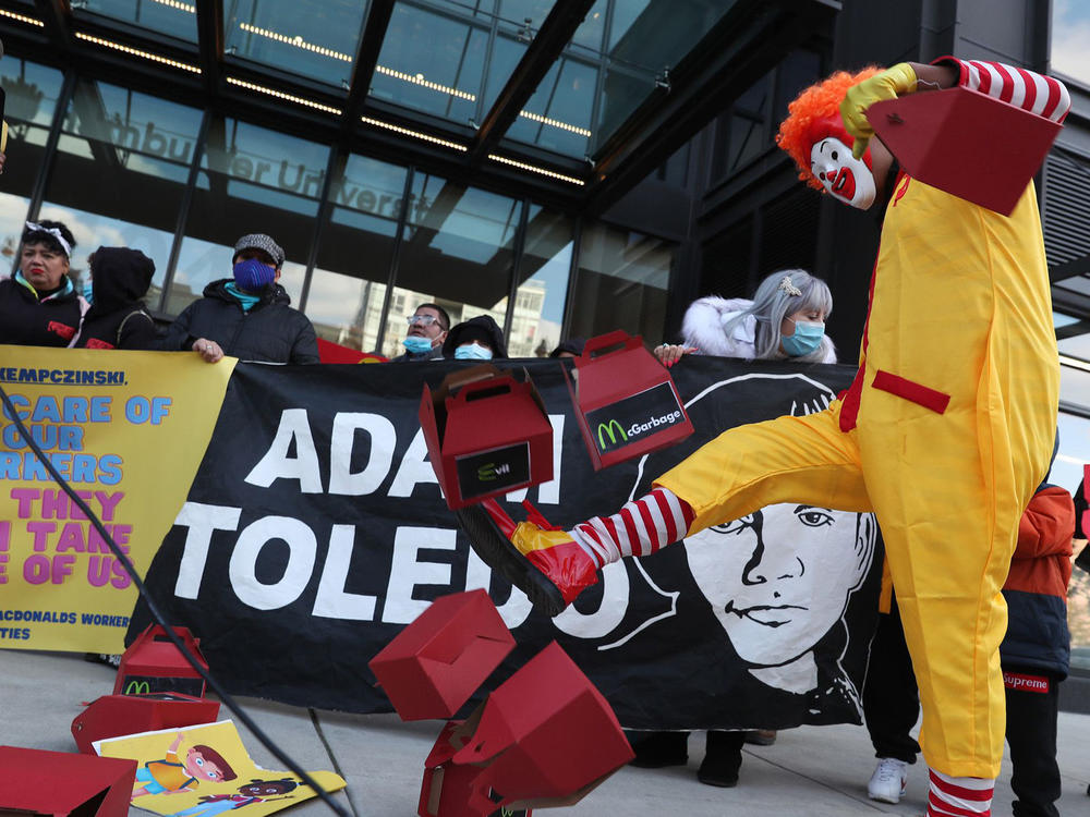 Dressed as Ronald McDonald, Kristian Armendariz kicks empty food boxes that resemble McDonald's Happy Meals during a protest outside the company's corporate office on Wednesday in Chicago. Protestors gathered to criticize McDonald's CEO Chris Kempczinski's text message to Mayor Lori Lightfoot, which referenced the fatal shootings of 7-year-old Jaslyn Adams and 13-year-old Adam Toledo.