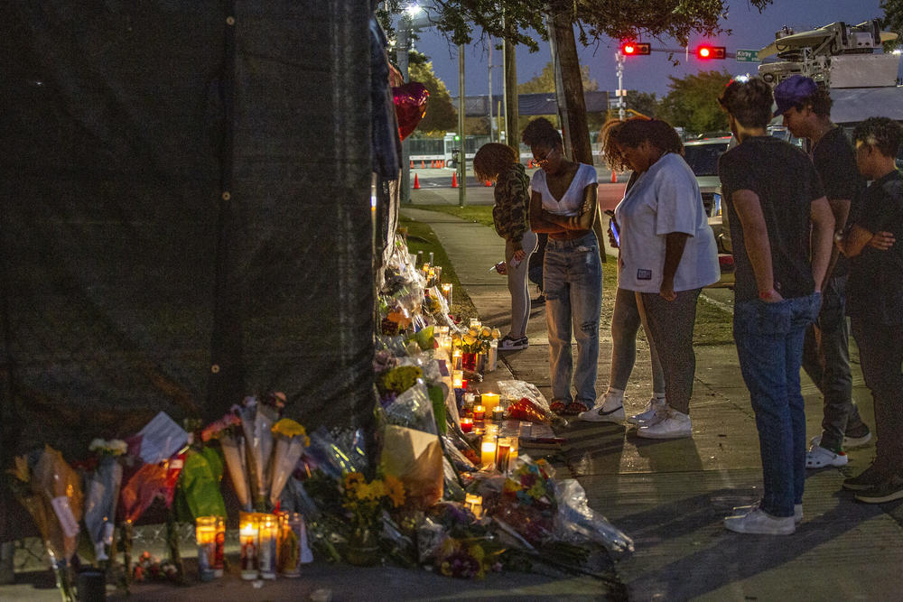 People attend a makeshift memorial on Sunday at the NRG Park grounds where eight people died during the Astroworld Festival in Houston.