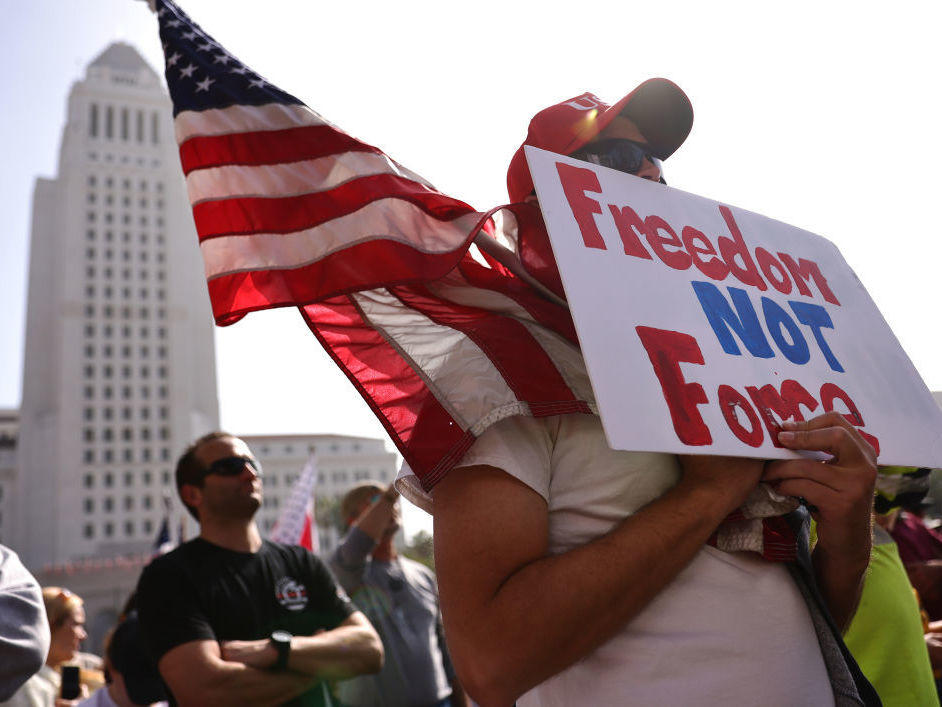 Protesters gather at a rally to demonstrate against the LA City Council's COVID-19 vaccine mandate for city employees and contractors on Monday in Los Angeles. A new study from the Pew Research Center breaks down ideology within political parties, including by views on the role of government.