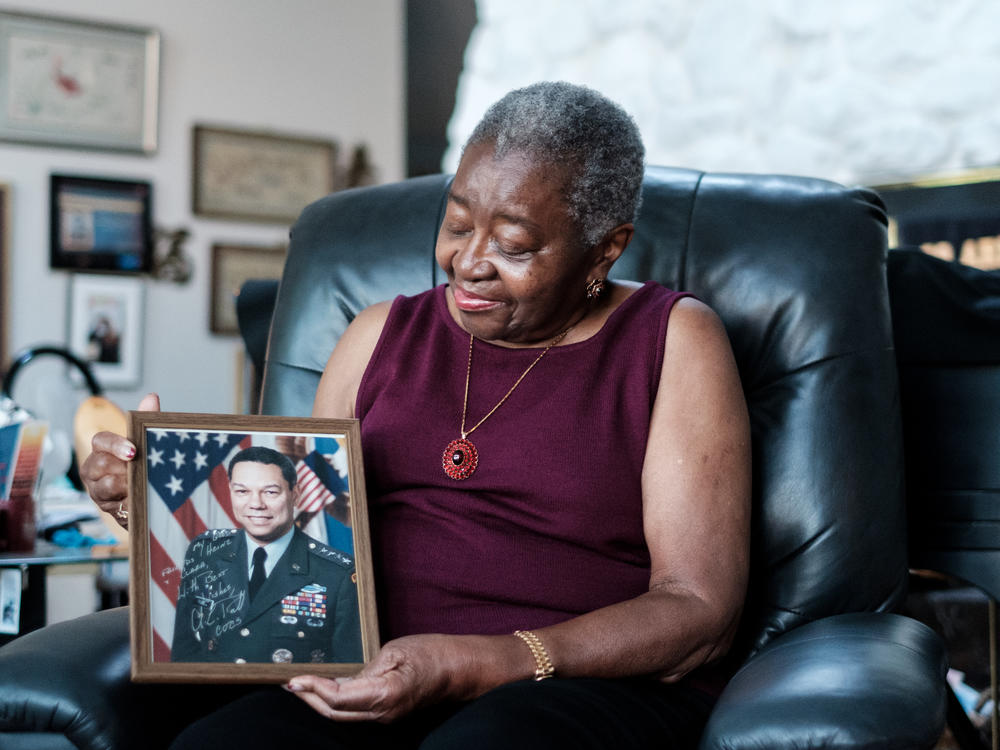 Retired Brigadier Gen. Clara Adams-Ender, the first woman to receive her master's degree in military arts and sciences from the U.S. Army Command and General Staff College holds a signed photo of Gen. Colin Powell, the first African American chairman of the Joint Chiefs of Staff.