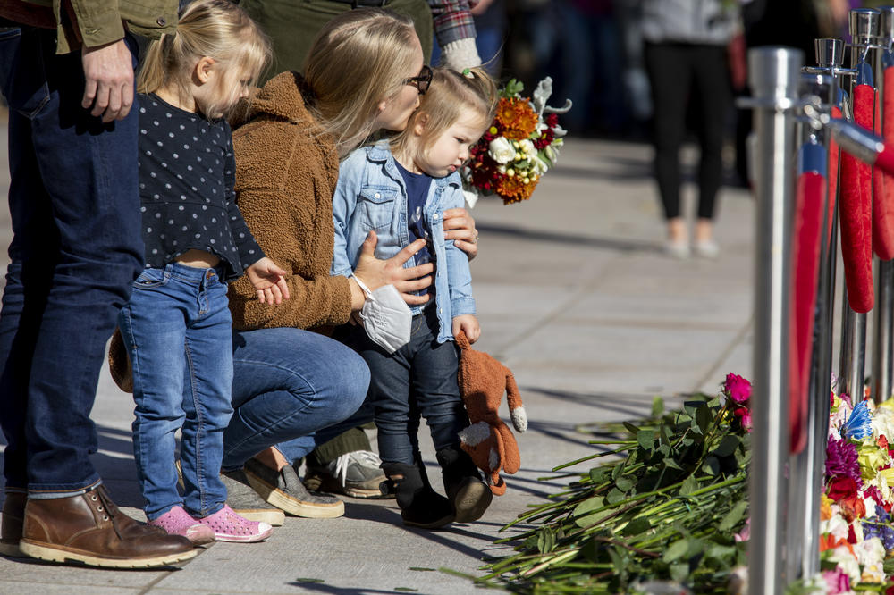 Stacy Wittmeyer kisses her daughter, Margaux Wittmeyer, 2, as her other daughter, Brynly Wittmeyer, 3, looks on after they and their family laid flowers at the Tomb of the Unknown Soldier during the centennial celebration.