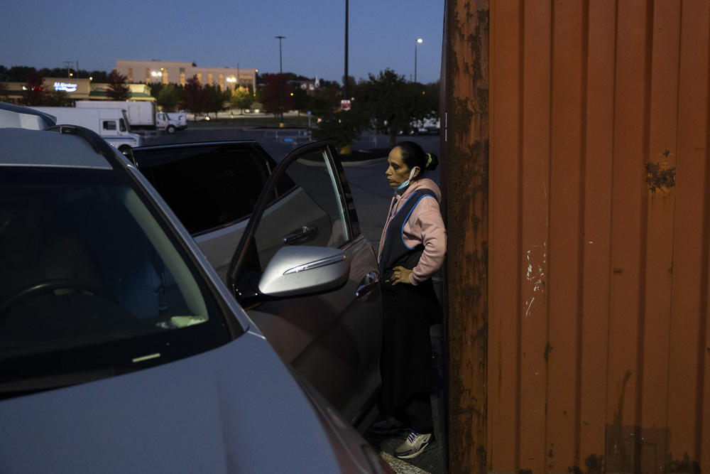 Veronica Vargas waits as her three boys get ready for school in the Walmart parking lot.