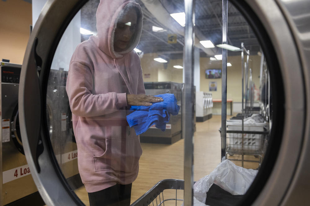 Vargas does her family's laundry at a laundromat in the evening.