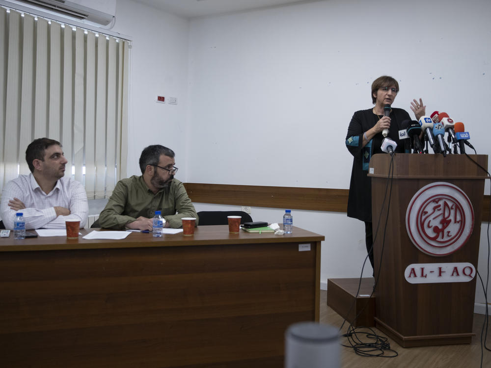 Ubai Aboudi, the head of Bisan Center (left), Addameer director Sahar Francis (right) and Tahseen Elayyan, from Al-Haq rights group hold a joint news conference in the West Bank city of Ramallah on Monday.