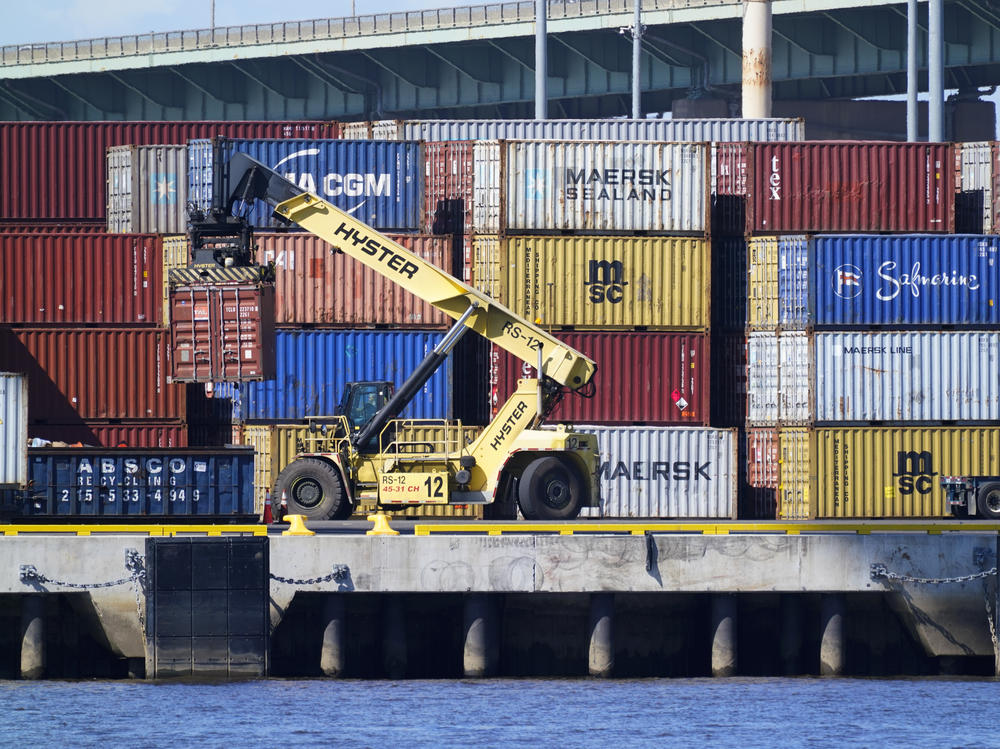 A shipping container is moved along the Delaware River in Philadelphia on Sept. 29. With Christmas fast approaching, businesses of all kinds are rushing to get their products onto shelves in time for the holidays.