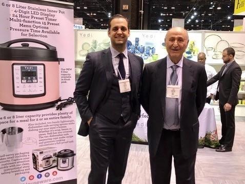 Bobby Djavaheri, president of Yedi Houseware Appliances, poses with his father, Yedidia, at the Chicago Houseware Show. Shipping delays have jeopardized a Black Friday promotion in which they hoped to sell more than $1 million worth of air fryers.