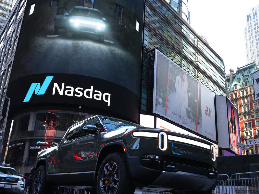 A Rivian electric truck is displayed near the Nasdaq MarketSite building in Times Square in New York City on Nov. 10. Rivian, an electric-truck maker backed by Amazon and Ford, made its debut on Nasdaq in one of the biggest initial public offerings in U.S. history.