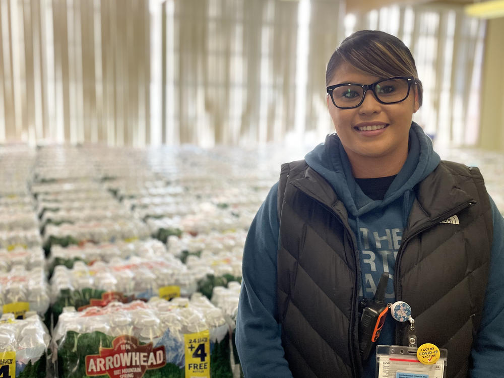 Dot Thurby with some of the thousands of water bottles the Confederated Tribes of Warm Springs distributes to members every day.