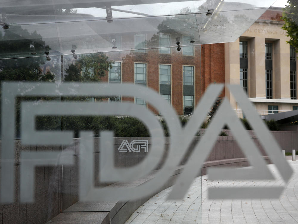 FILE - This Thursday, Aug. 2, 2018, file photo shows the U.S. Food and Drug Administration building behind FDA logos at a bus stop on the agency's campus in Silver Spring, Md.