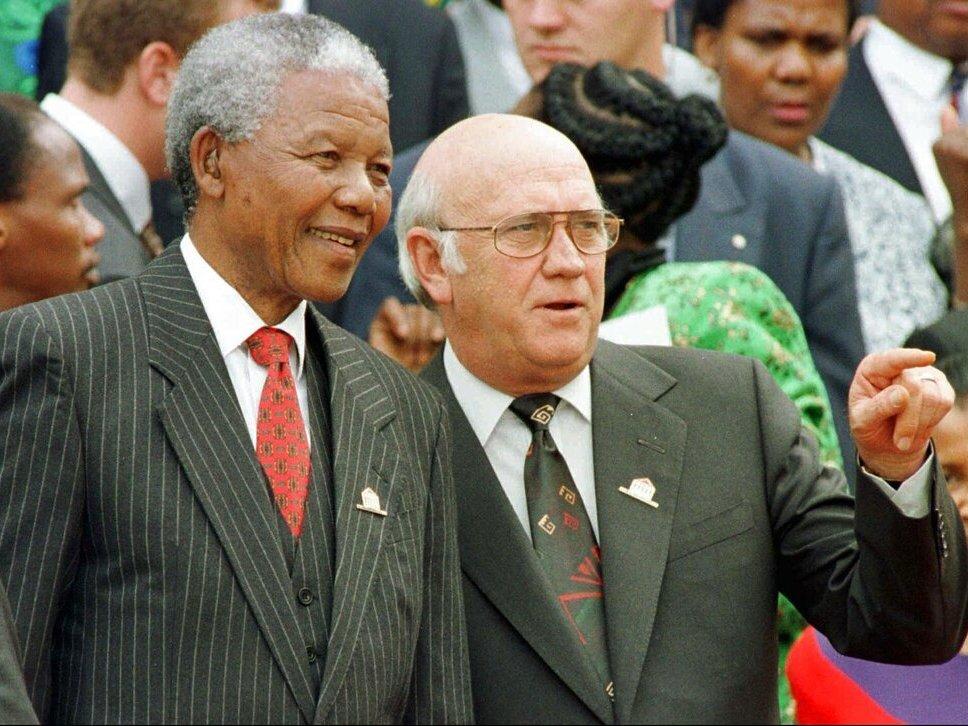South African President Nelson Mandela, left, and Deputy President F.W. de Klerk chat on May 8, 1996, outside Parliament after the approval of South Africa's new constitution. F.W. de Klerk, who oversaw the end of South Africa's country's white minority rule, has died at 85 it was announced Thursday.