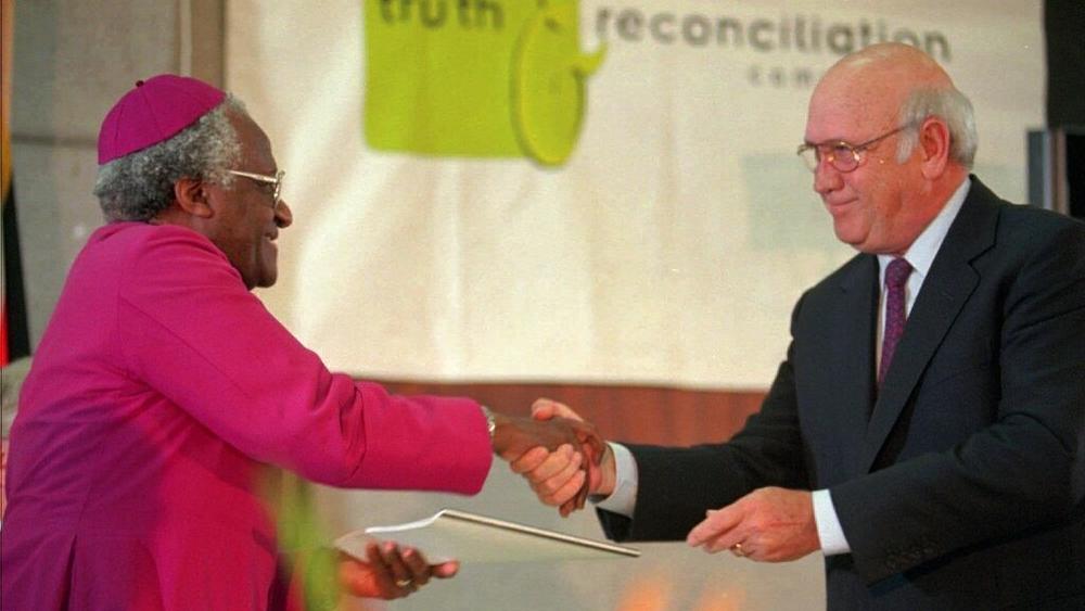 National Party leader F.W. de Klerk, right, hands over the National Party's 30-page submission to the Truth and Reconciliation Commission to the chairman Archbishop Desmond Tutu in August 1996 in Cape Town, South Africa.
