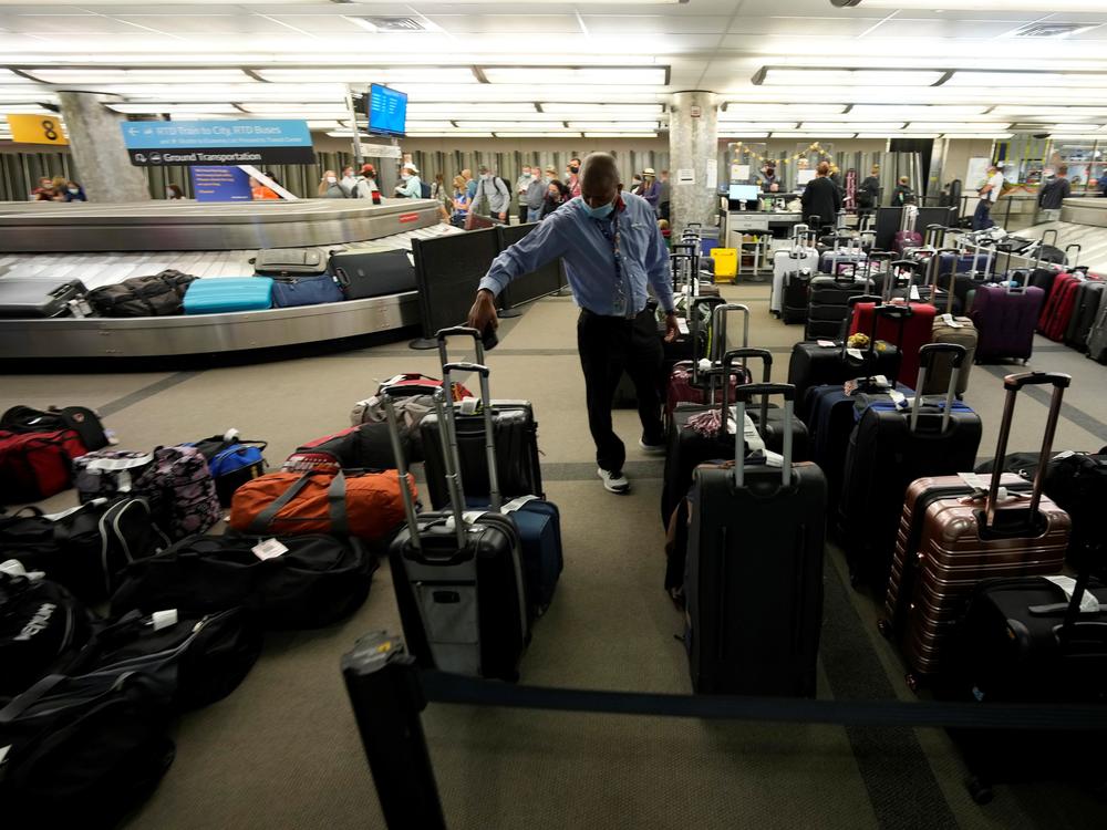Unclaimed baggage wells up between carousels for passengers arriving on Southwest Airlines flights at Denver International Airport late Sunday, Oct. 10, in Denver.