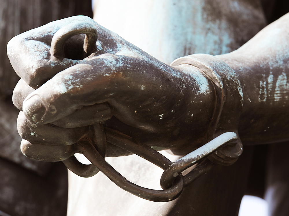 The chained hand of Archer Alexander, who was the last slave captured under the fugitive slave law, is depicted in a statue commemorating the Emancipation Proclamation. A bill to study reparations for slavery advanced through a House committee this year but hasn't gotten a floor vote.