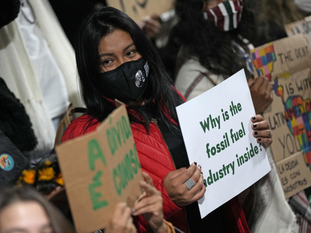 Youth climate activists protest on Thursday that representatives of the fossil fuel industry have been allowed inside the venue during the COP26 U.N. Climate Summit in Glasgow.