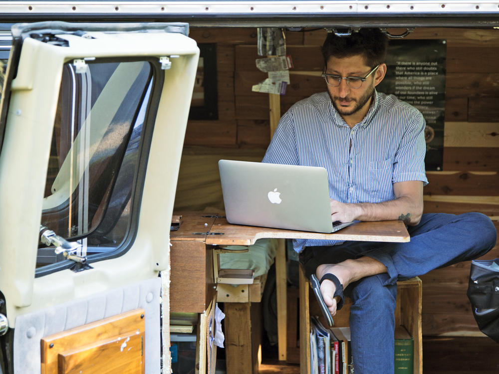 U.S. journalist Danny Fenster works out of his van that he made into a home/office in Detroit in 2018. Fenster's lawyer says a court in military-ruled Myanmar sentenced him Friday to 11 years in prison after finding him guilty on several charges including incitement for allegedly spreading false or inflammatory information.