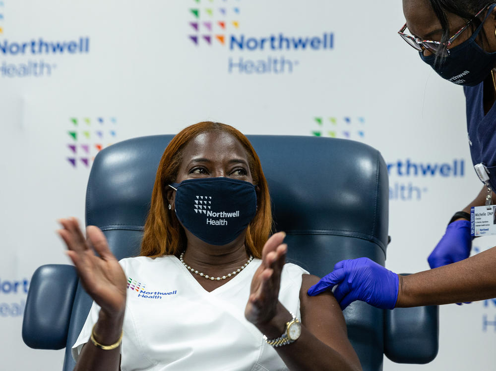 Nurse Sandra Lindsay celebrates after receiving her COVID-19 Pfizer vaccine booster at Long Island Jewish Medical Center in New York in October. Lindsay was the first person known to receive a COVID vaccine in the United States vaccination campaign — on Dec. 14, 2020. Her vaccination card is displayed at the COVID-19 exhibit in the Smithsonian Museum of American History.