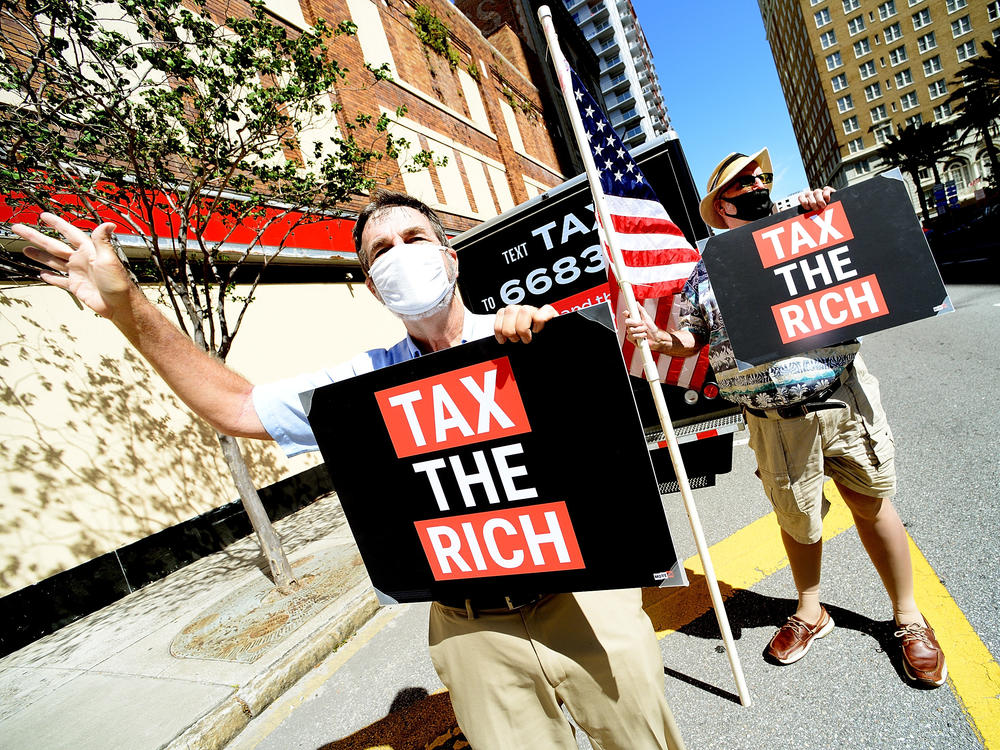 Two protesters from progressive group MoveON calling for higher taxes for the rich and corporations in Tampa, Fl., on May 17. Polls typically show support for increasing taxes for the wealthy.