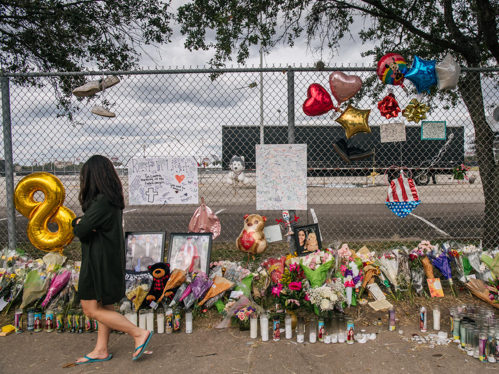A woman walks past a memorial to those who died at the Astroworld Festival outside of NRG Park on Nov. 9, 2021 in Houston.