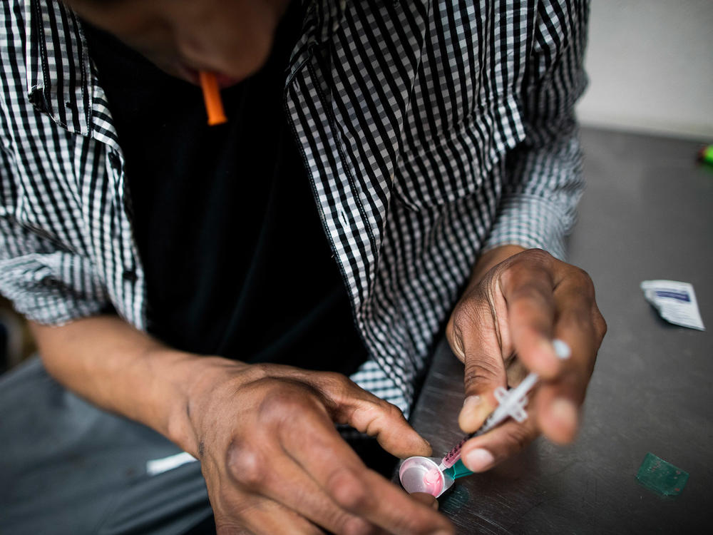 A drug user prepares to inject himself with heroin inside VANDU's supervised injection room in Vancouver, Canada. Similar sites to the ones implemented in New York have proven successful in Canada.
