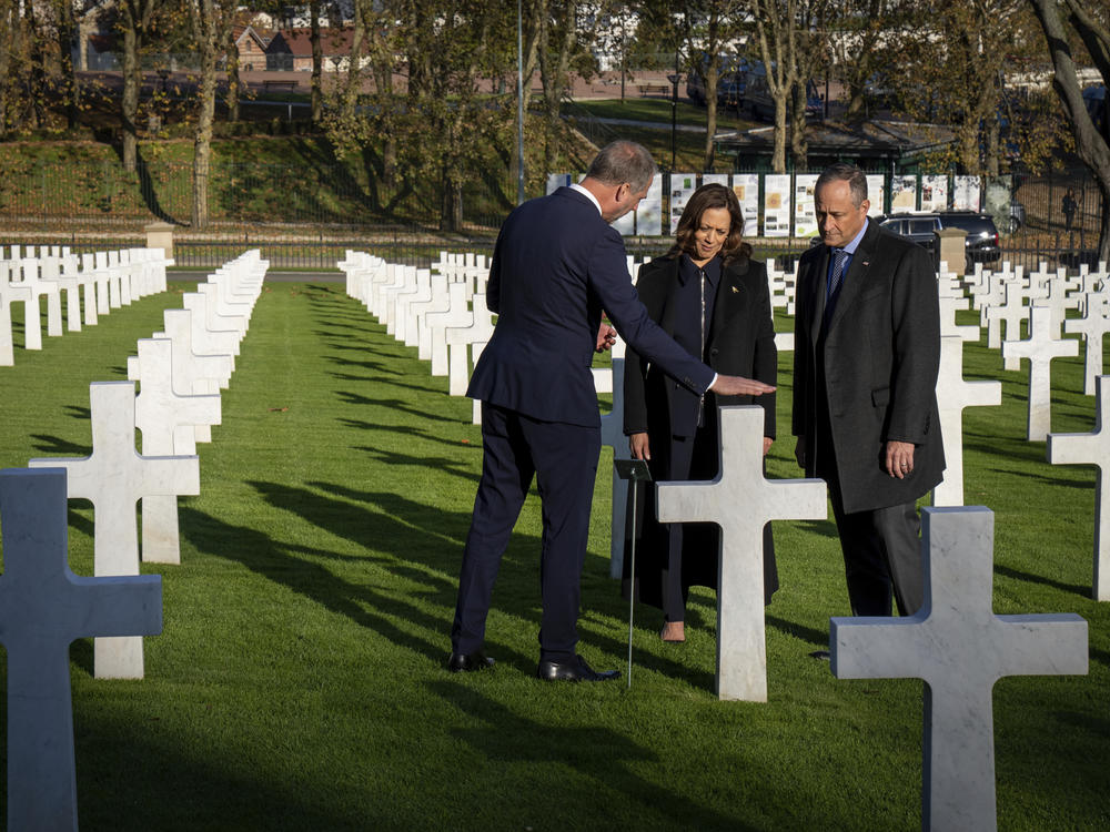 Keith Stadler, the superintendent of the Suresnes American Cemetery, speaks with Vice President Harris and her husband, Doug Emhoff, on Nov. 10.
