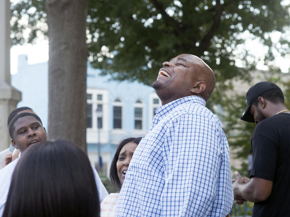 Dontae Sharpe reacts outside the Pitt County Courthouse after a judge determined he could be set free on Aug. 22, 2019, in Greenville, N.C. North Carolina Gov. Roy Cooper on Friday pardoned Sharpe, who spent 24 years behind bars for a murder he has long said he did not commit.