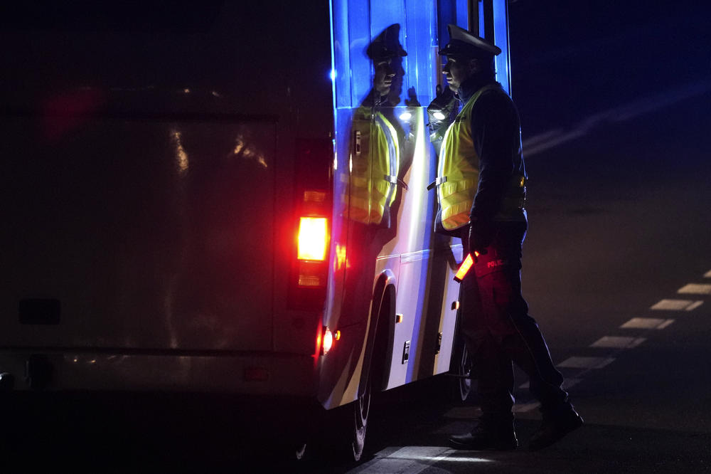 A polish police officer checks a bus near the border to Belarus, that was closed because of a large group of migrants camping in the area on the Belarus side who had tried to illegally push their way into Poland and into the European Union, in Kuznica, Poland, Friday, Nov. 12, 2021.