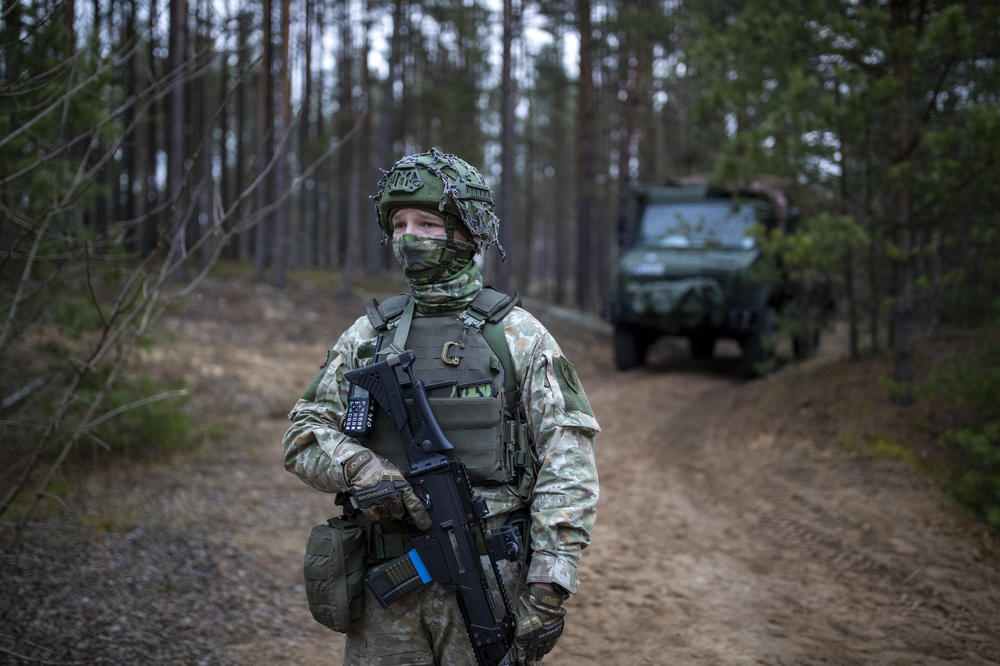 A Lithuanian soldier patrols a road near the village of Jaskonys, in Lithuania near the border with Belarus, Saturday. EU members Poland and Lithuania say they are struggling to cope with an unusually high number of migrants arriving at their borders with Belarus in recent months.
