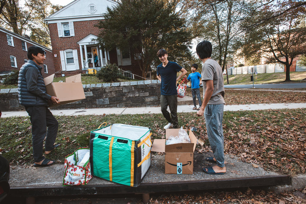 Shahid Mahrammi (right), Jawed Yagana and Hossein Mahrammi unload donations for the Yagana family.