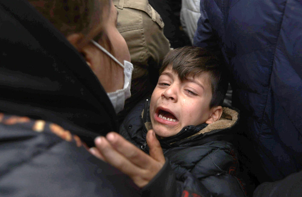 A migrant boy reacts in a tent camp on the Belarusian-Polish border. Since the start of 2021, migrants have been heading to the border of Belarus with Poland, Lithuania and Latvia.