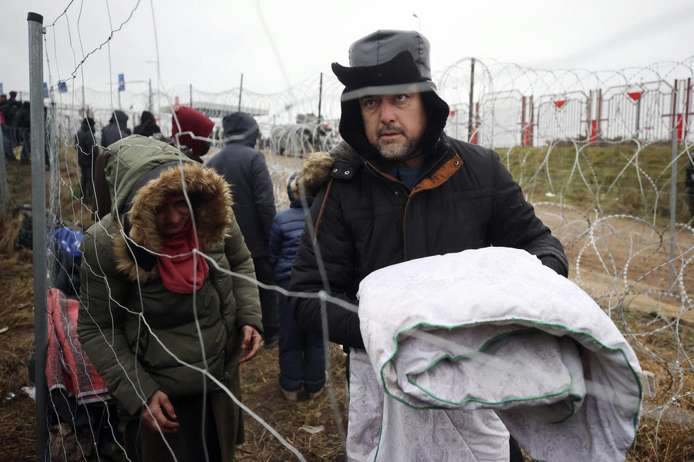 A group of migrants are seen near the Belarusian-Polish border in the Grodno region, in Belarus, on Saturday. Western countries have accused the Belarusian regime, which is backed by Russia, of engineering the crisis in retaliation against EU sanctions, charges that Minsk has denied.