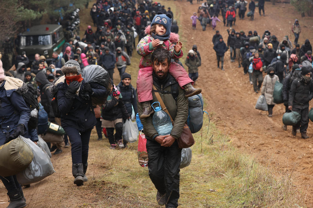 Migrants gather on the Belarusian-Polish border near the crossing at Kuznica, Poland, on Monday.