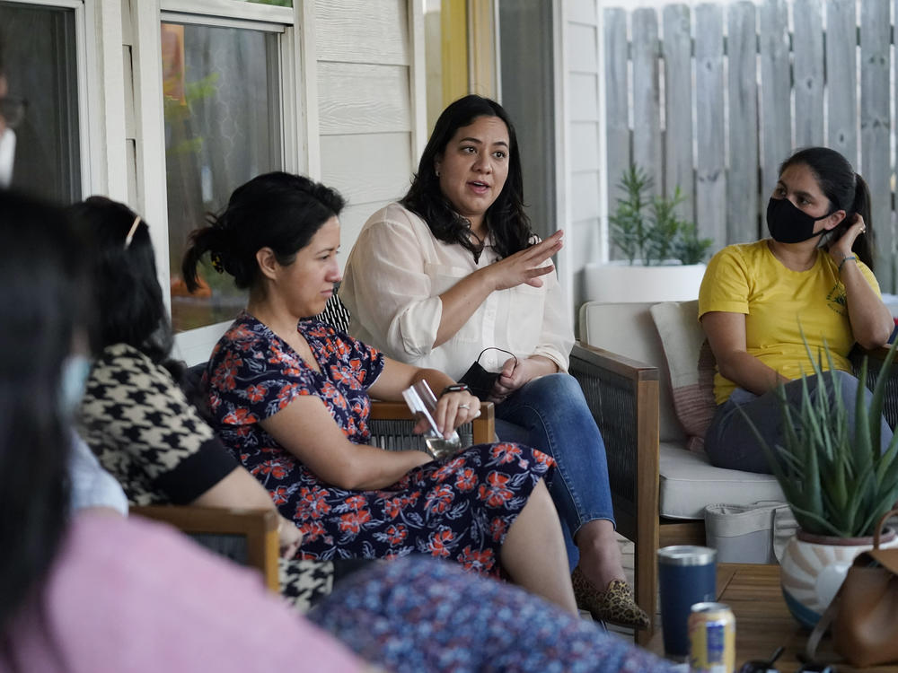 Democratic congressional candidate Rochelle Garza speaks with voters in Brownsville, Texas, in September. Many Latino voters in South Texas turned against Democrats during last year's presidential election — and winning them back could prove critical to the party's hopes of retaining control of Congress during next year's midterms.