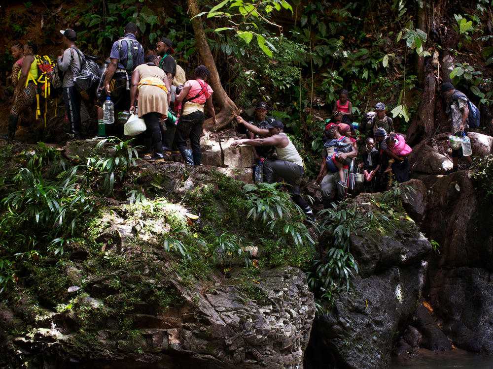 Migrants from Haiti get caught on a crevasse along the Acandiseco river, Colombia.
