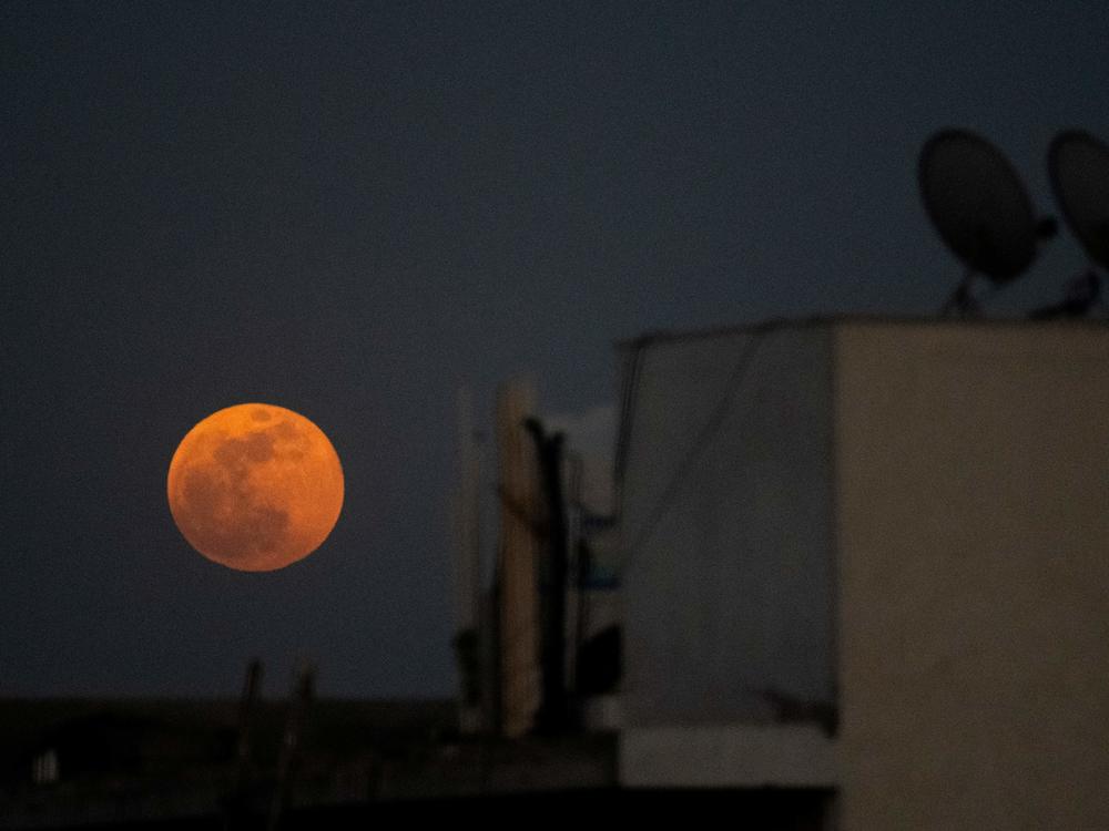 The super blood moon rises over a residential area in New Delhi during a total lunar eclipse in May.