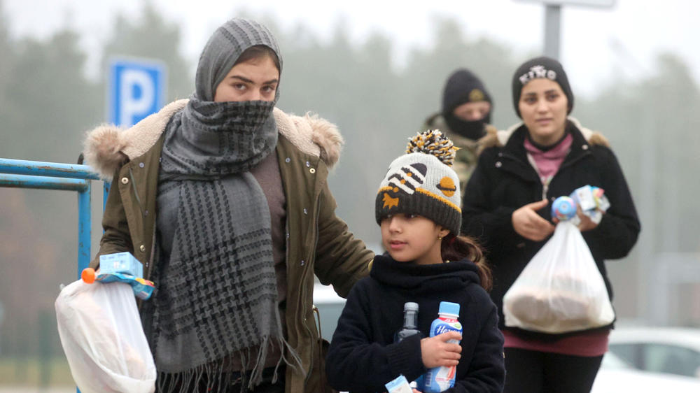 Migrants receive humanitarian aid in a tent camp near the Bruzgi checkpoint, on Wednesday.