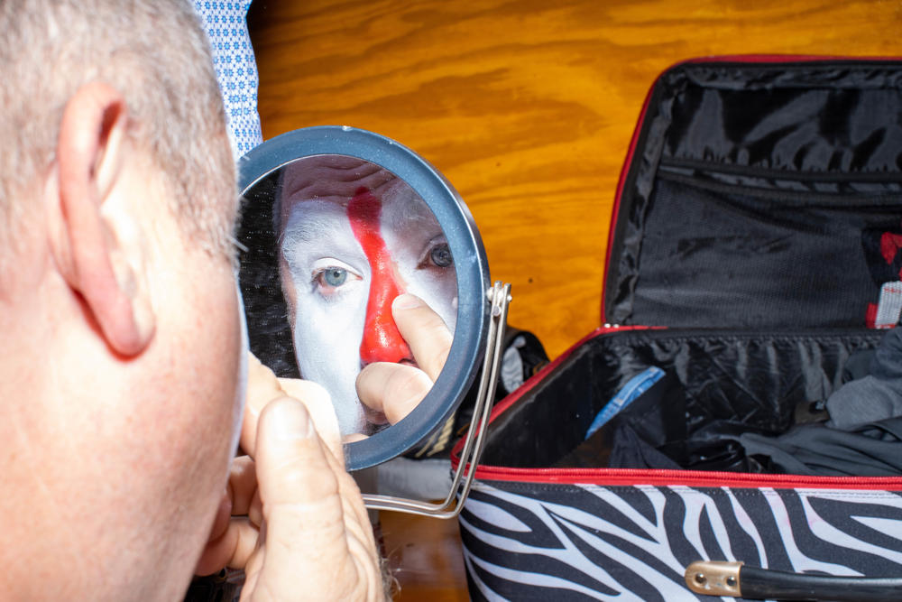 Rob Gann puts on his clown makeup in the backstage locker room at the Adirondack Stampede Rodeo in Glens Falls, N.Y.