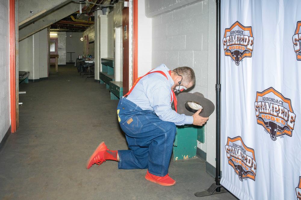 Gann, who works as a rodeo clown, prays backstage before entering the arena.