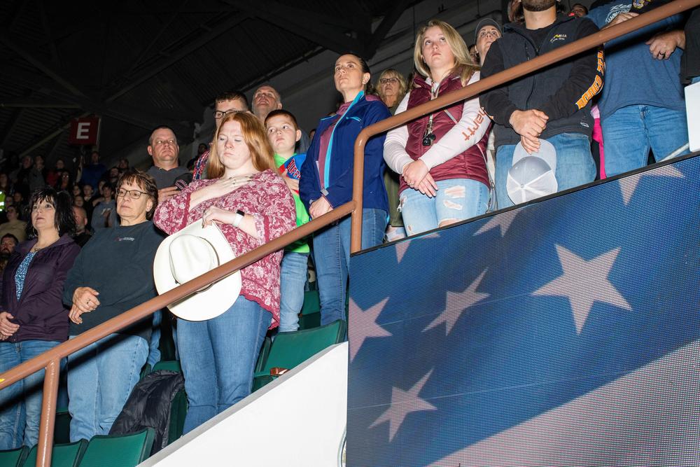 Spectators pray before the Adirondack Stampede in the Cool Insuring Arena in Glens Falls, N.Y.