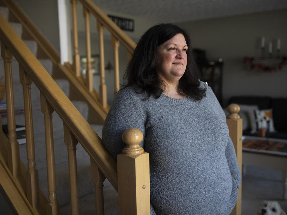 Lauren Barber stands in her home in Columbus, Ohio, on Nov. 16. Barber has been inundated with offers from investors and companies that want to buy her house. She sometimes gets called or texted more than five times a day with offers.