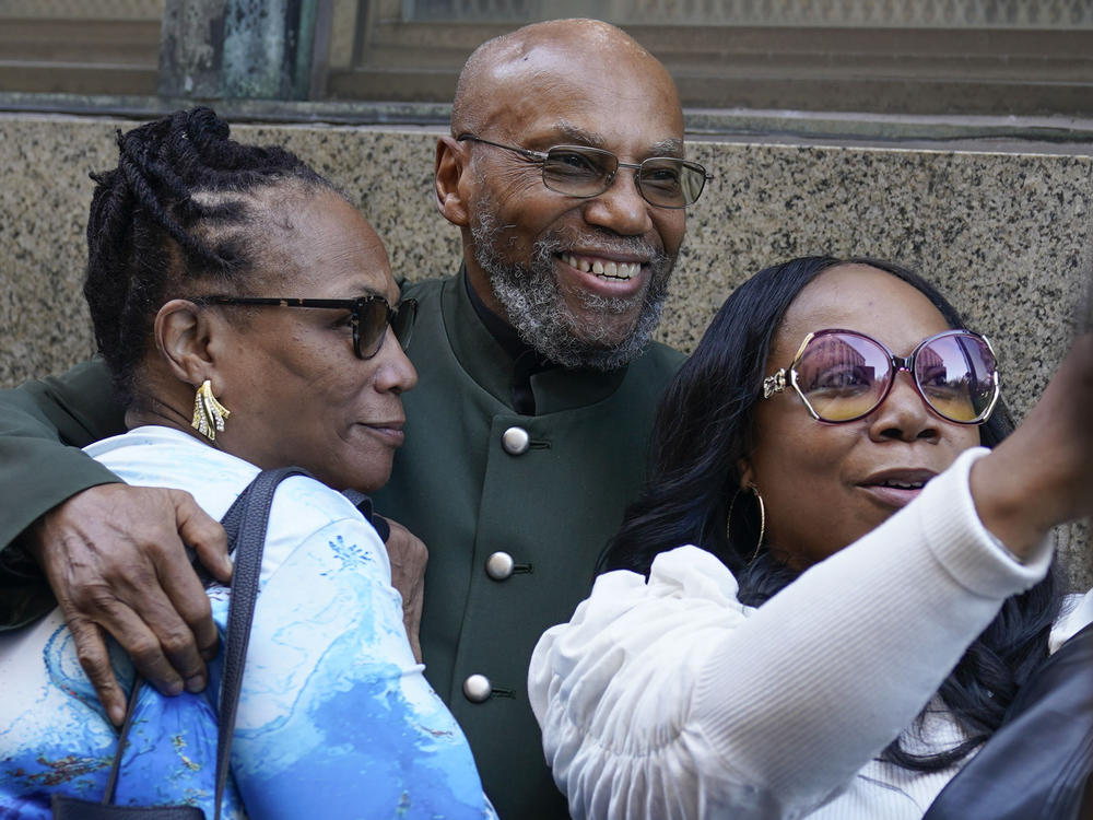 Muhammad Aziz, center, stands outside the courthouse with members of his family after his conviction in the killing of Malcolm X was vacated on Thursday in New York. A Manhattan judge dismissed the convictions of Aziz and the late Khalil Islam, after prosecutors and the lawyers said a renewed investigation found new evidence that the men were not involved with the killing.